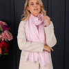 Ultrafine Ring Shawl in Soft Pink worn with light neutral jacket, with dark background