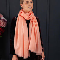 Luxuriously soft merino and silk shawl in coral twill weave with a soft fine fringe generous size light and airy beautifully warm best-quality