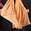 Luxuriously soft merino and silk shawl in peach twill weave with a soft fine fringe generous size light and airy beautifully warm best-quality