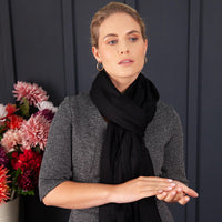 Luxuriously soft merino and silk shawl in a Black twill weave with a soft fine fringe generous size light and airy beautifully warm best-quality