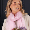 Ultrafine Ring Shawl in Soft Pink from The Wool Company, worn with light neutral jacket.