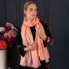 Luxuriously soft merino and silk shawl in coral twill weave with a soft fine fringe generous size light and airy beautifully warm best-quality