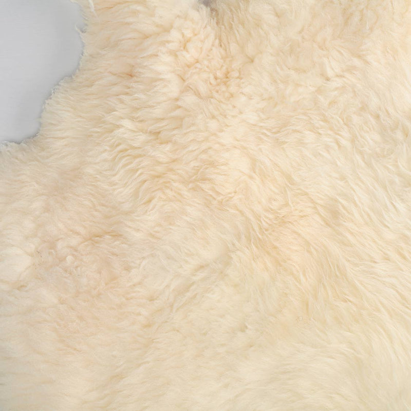 Soft, thick, & supportive British economy sheepskin pet bed or economical rug for the home or garden in natural creamy tones