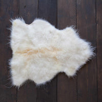 Soft, thick, & supportive British economy sheepskin pet bed or economical rug for the home or garden in natural creamy tones