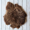 Soft, thick, & supportive British economy sheepskin pet bed or economical rug for the home or garden in chocolate brown tones