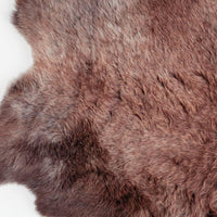 Soft, thick, & supportive British economy sheepskin pet bed or economical rug for the home or garden in chocolate brown tones